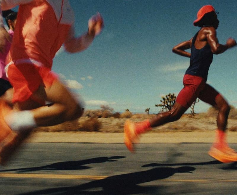 Runners racing along a sunny road